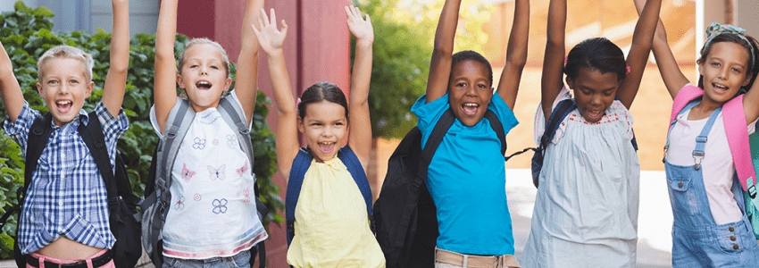 school kids with hands in air