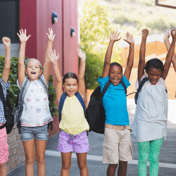 school kids with hands in air